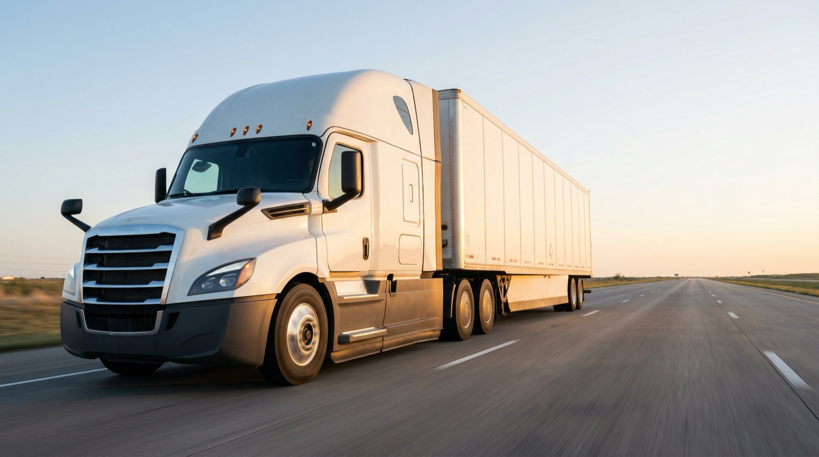 Semi truck on the highway at sunset